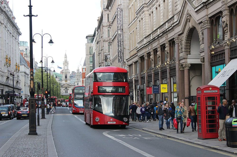 Red buses and taxis on the Strand near Charing Cross, London